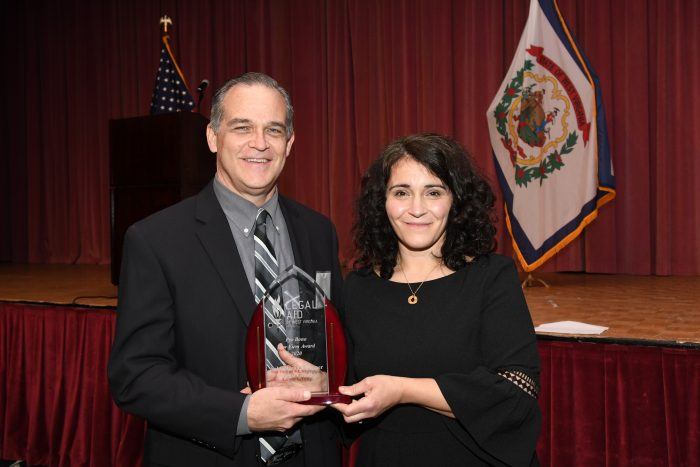 Jeff Culpepper accepts pro bono award plaque from Kate White
