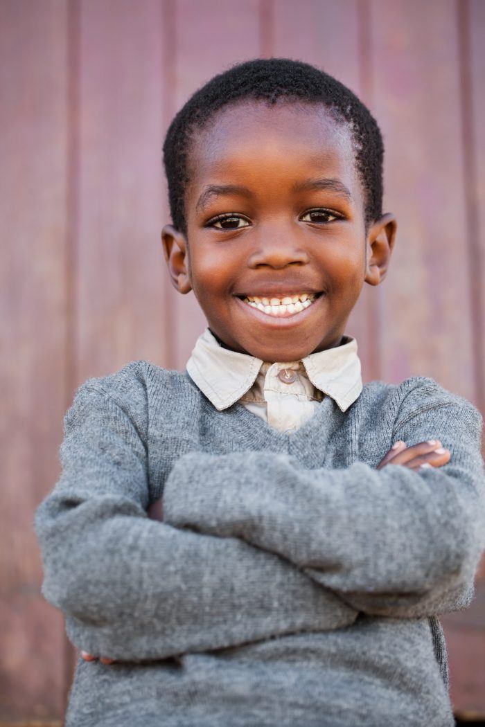 young boy smiles at camera