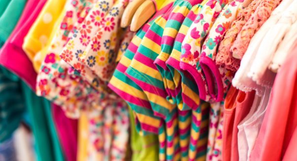 colorful childrens clothing hanging on rack