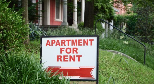 sign on lawn reads apartment for rent
