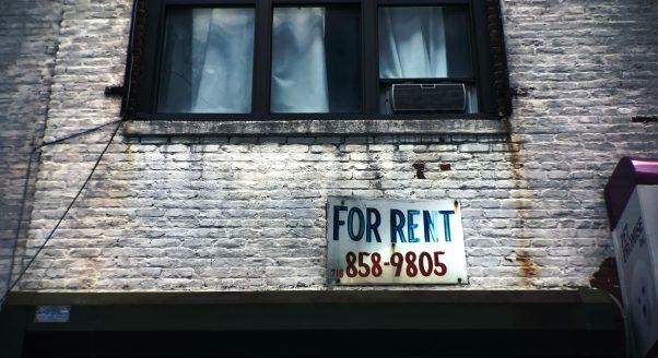 Apartment building with for rent sign