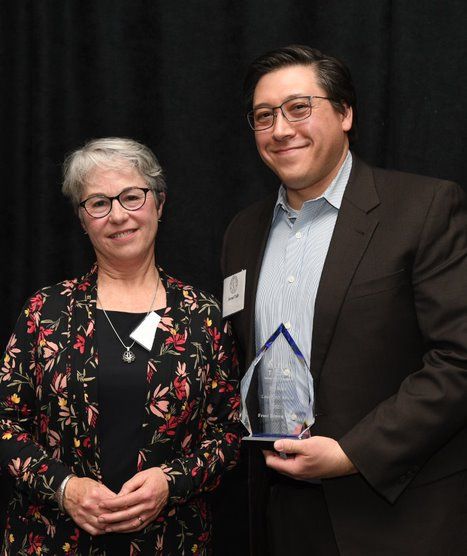 Jared Tully of Frost Brown Todd accepts Distinguished Pro Bono Firm Award from Legal Aid Executive Director Adrienne Worthy