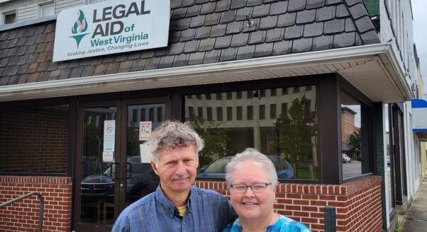 Clients Bobby and Lisa stand together outside the Legal Aid office where they got help