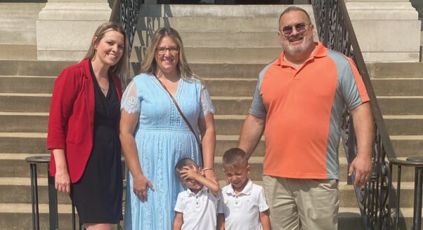 Legal Aid attorney Barbie Finley (far left) with clients Amanda and John and their twin sons on adoption day.