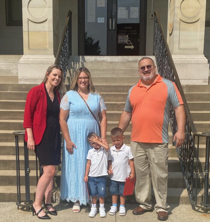 Legal aid attorney Barbie Finley (far left) with clients Amanda and John and their twin sons. 