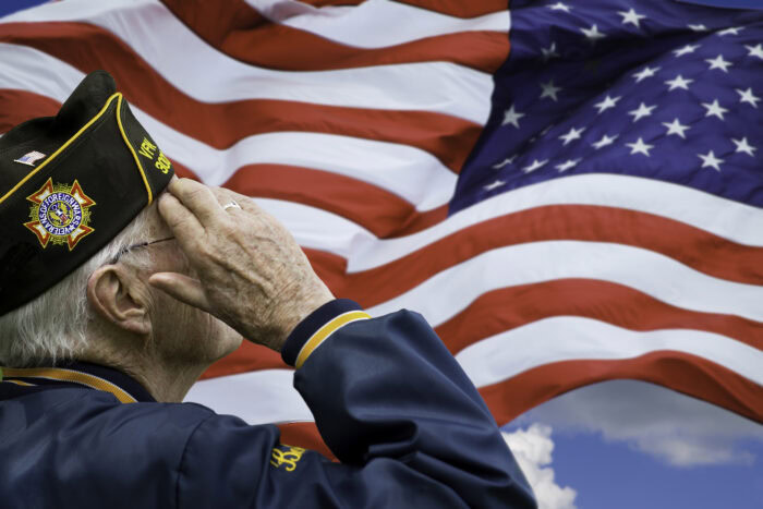 older us veteran salutes American flag