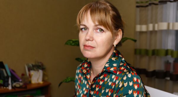 woman with serious expression looks at camera