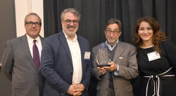 Emmett Pepper and Andy Nason (center left and center right) accept 2025 award