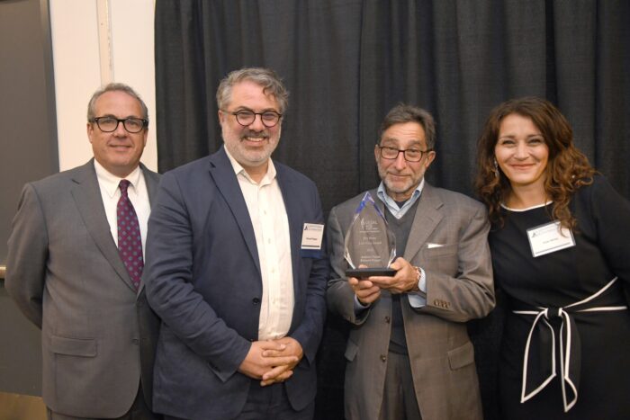 Emmett Pepper and Andy Nason (center left and center right) accept 2025 award