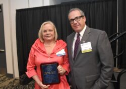Paula Harbour (left) accepts the 2025 Kaufman Award