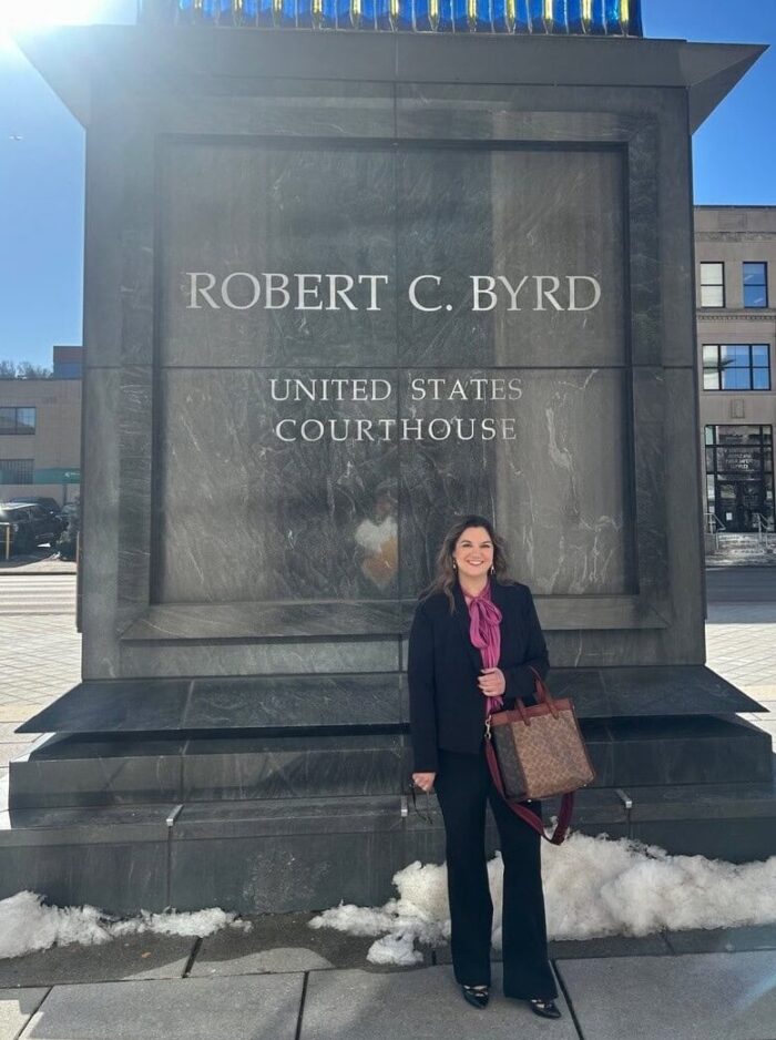 Kaylie Allen stands in front of the Robert C Byrd United States Courthouse